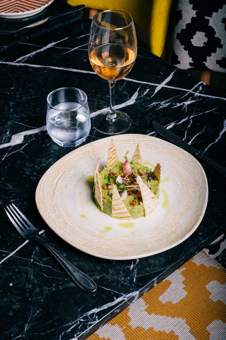 Elegant Moroccan bedroom with a four-poster bed, dark wood paneling, and sophisticated decor, warm and intimate