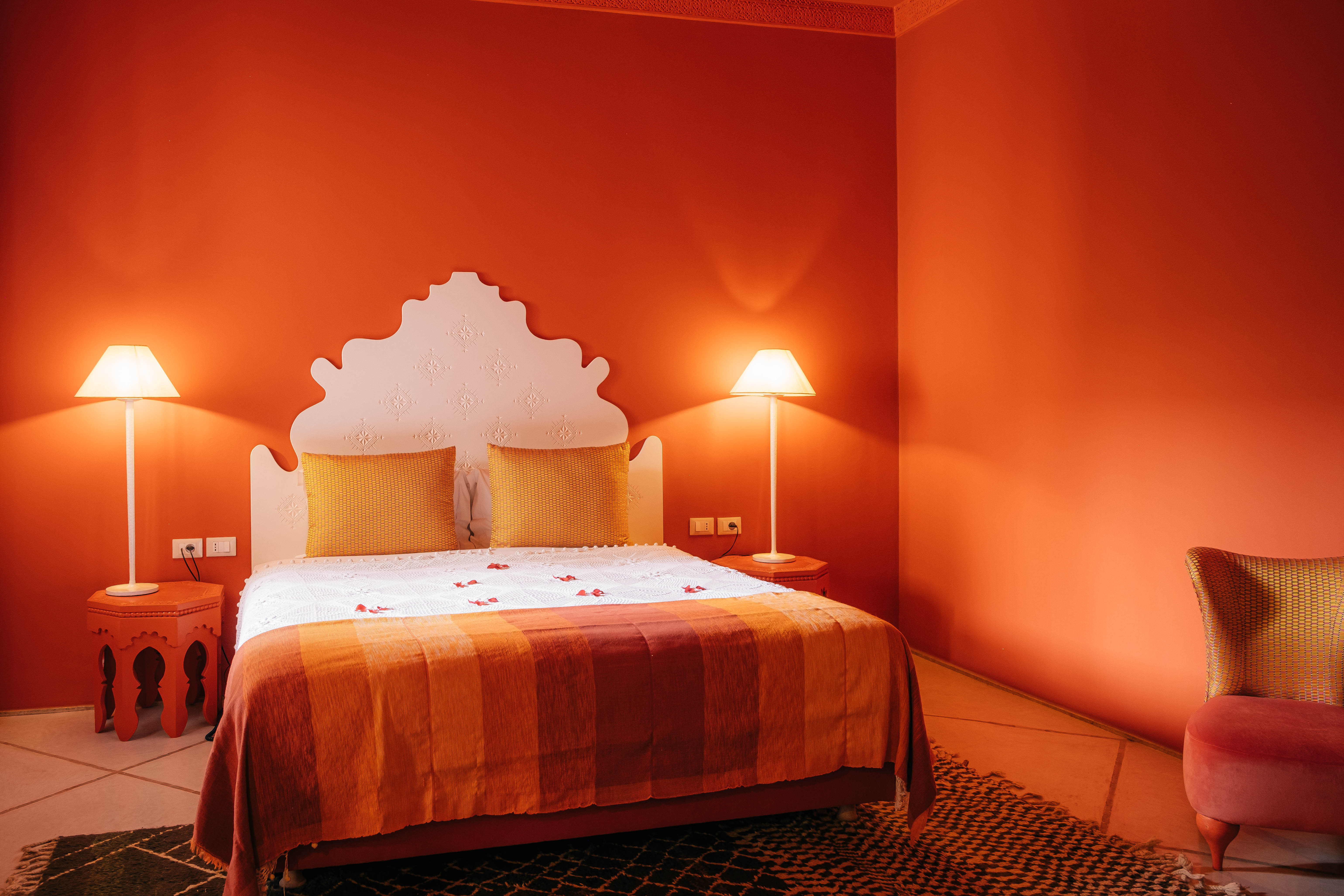 Cozy Moroccan comfort room at golden hour, warm ambient lighting, traditional decor, inviting atmosphere, luxury hotel photography
