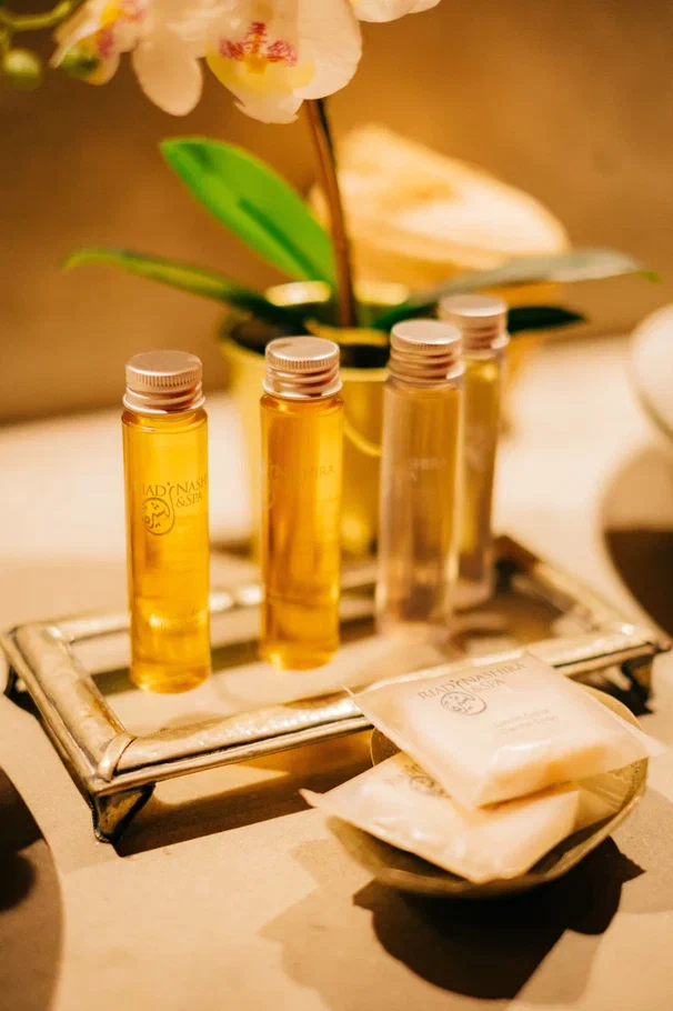 Traditional Moroccan tadelakt bathroom with Italian shower, natural stone, warm lighting, luxury hotel amenities