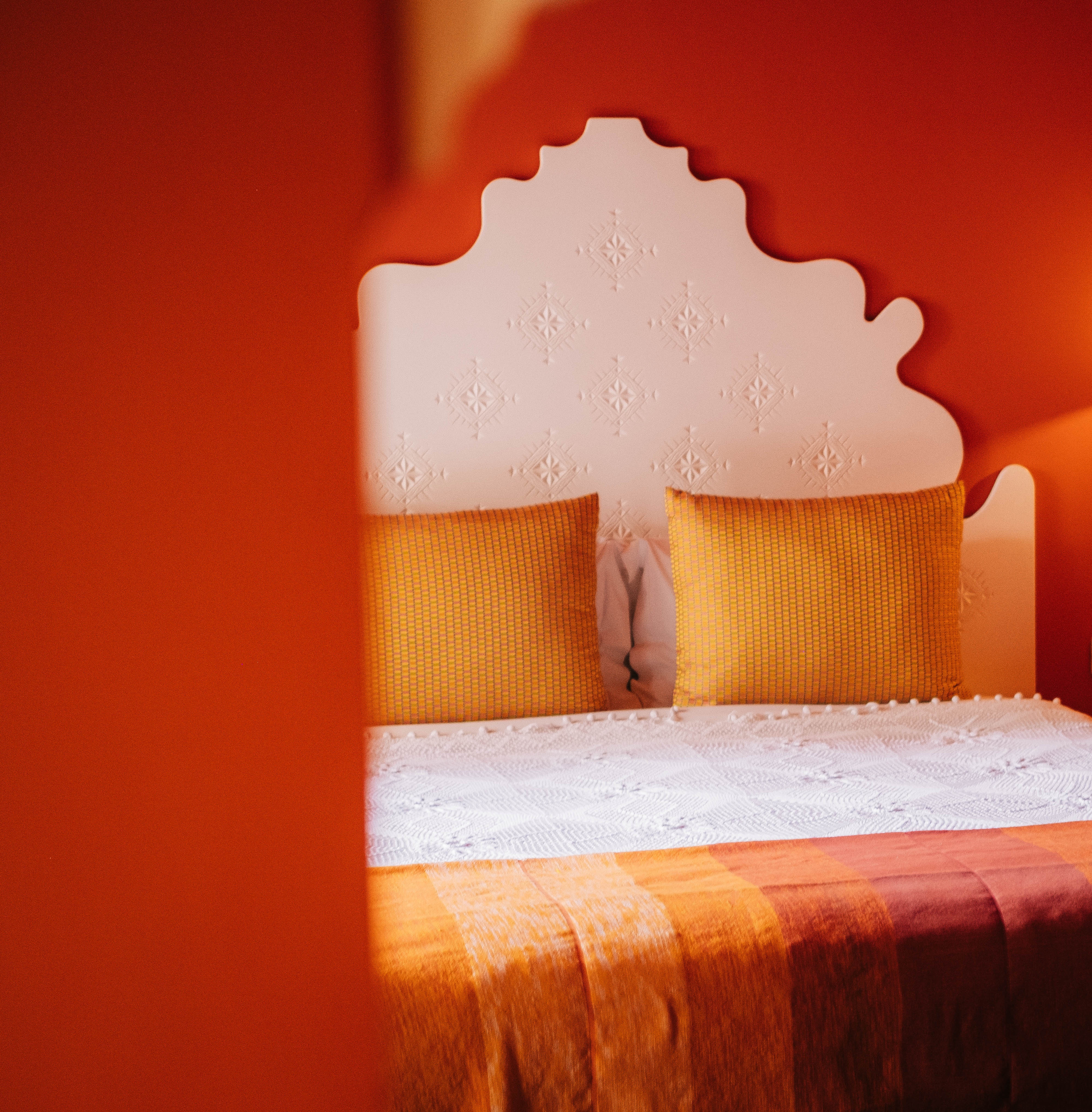 Intimate seating area in Moroccan comfort room with traditional cushions, low table, warm ambiance, authentic decor