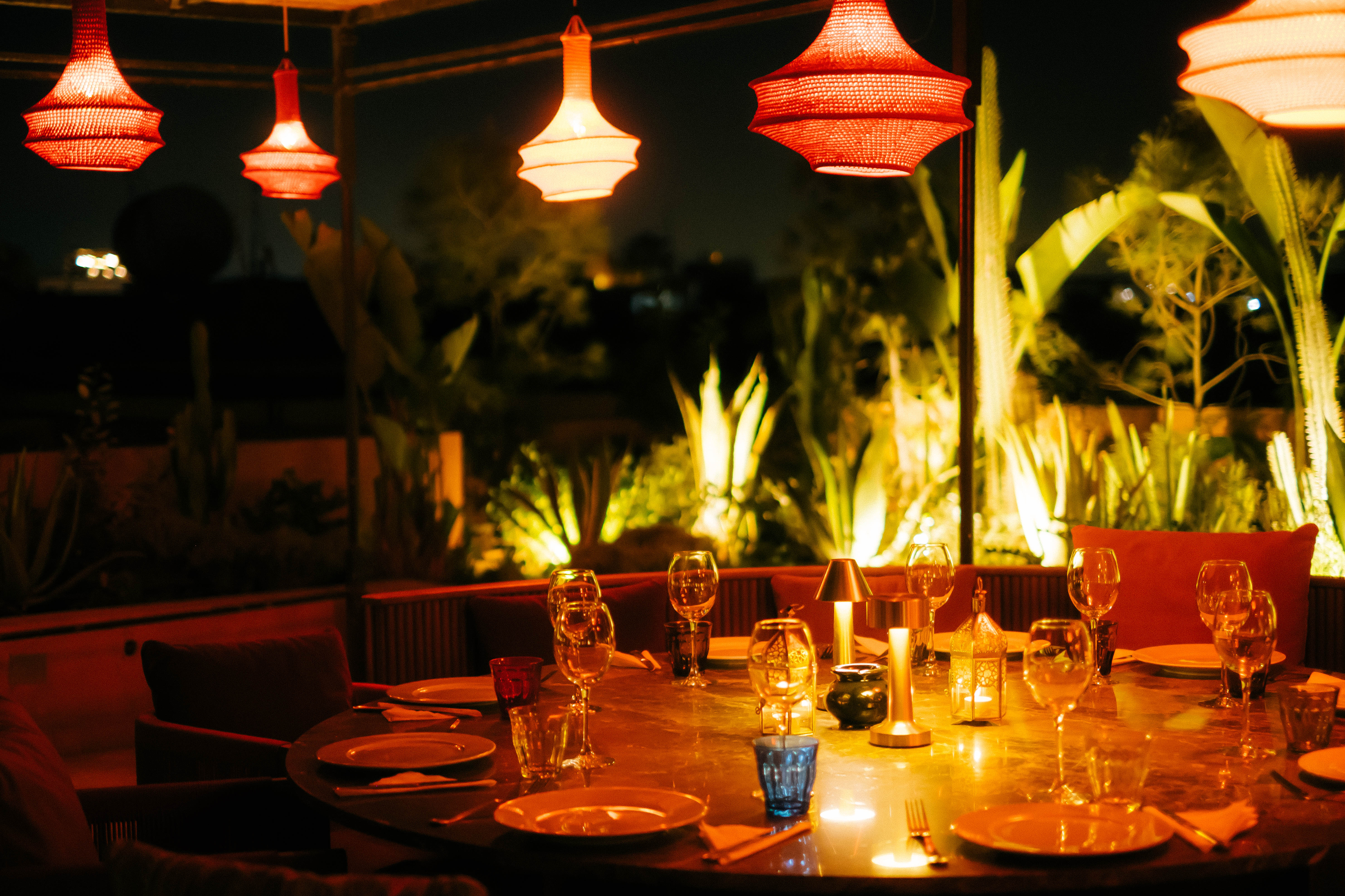 Elegant Moroccan bedroom with a four-poster bed, dark wood paneling, and sophisticated decor, warm and intimate