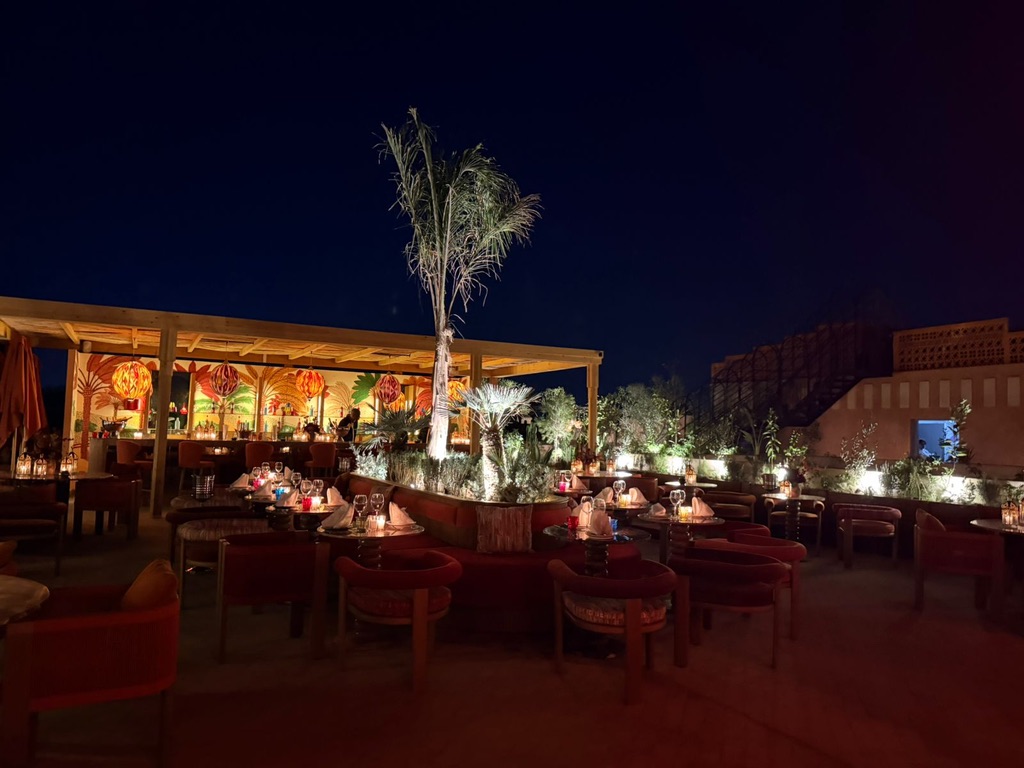 Modern conference room in luxury Moroccan hotel with elegant seating, audiovisual equipment, natural lighting, professional business setting