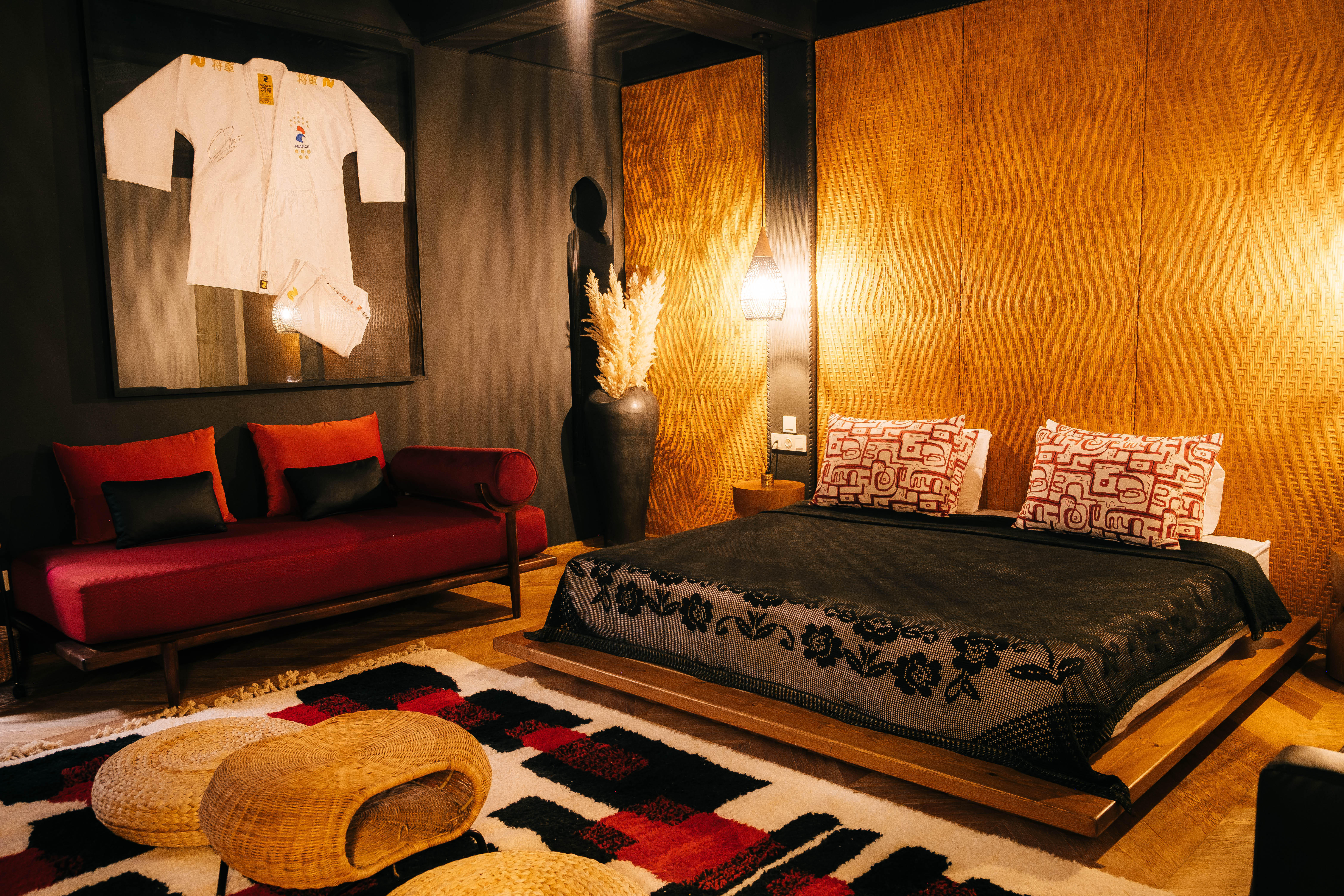 Comfortable seating area in a Moroccan riad with colorful patterned cushions against a backdrop of intricate zellige tiles, vibrant and detailed