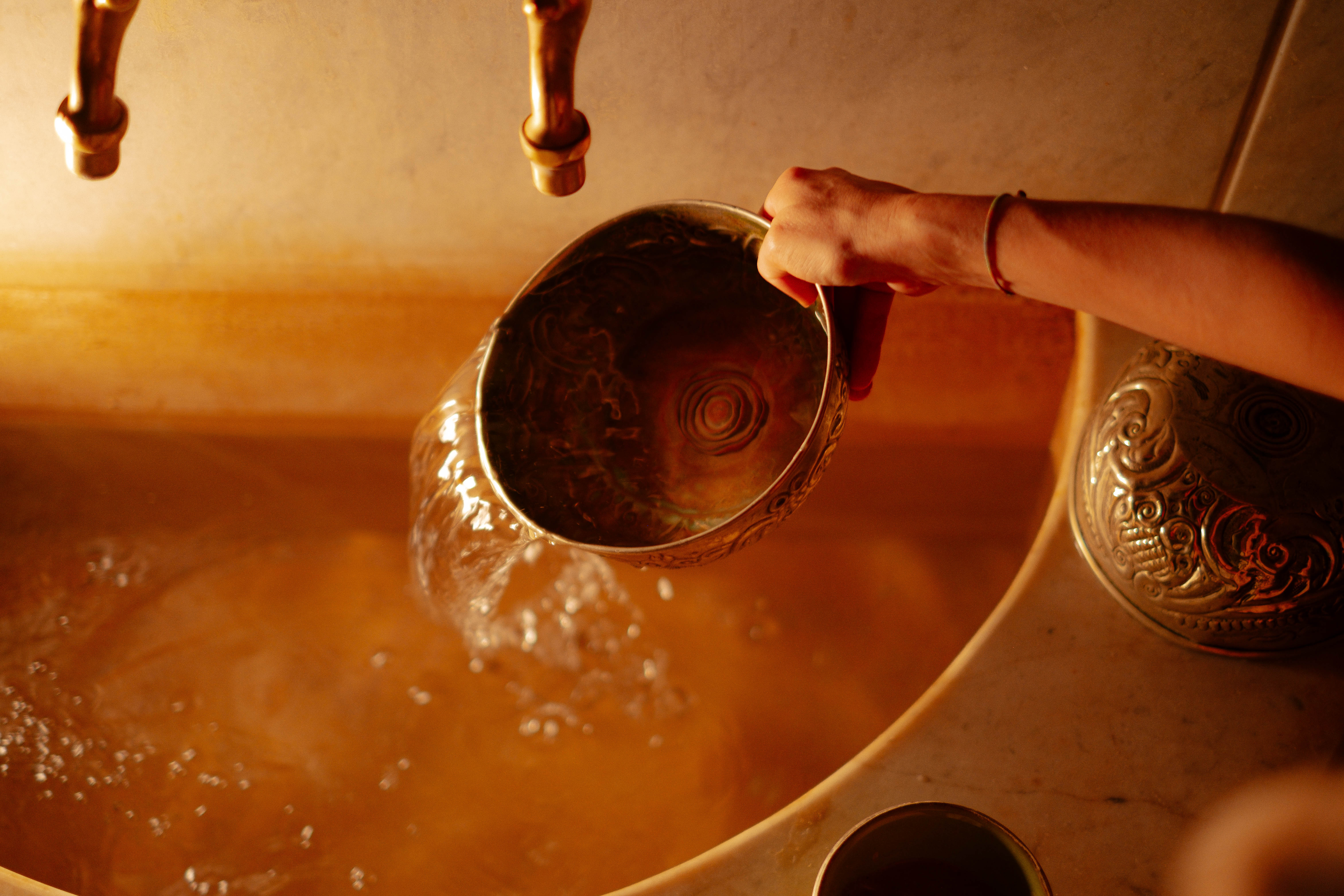 Traditional Moroccan hammam interior with marble surfaces, steam, warm lighting, authentic architecture, spa luxury