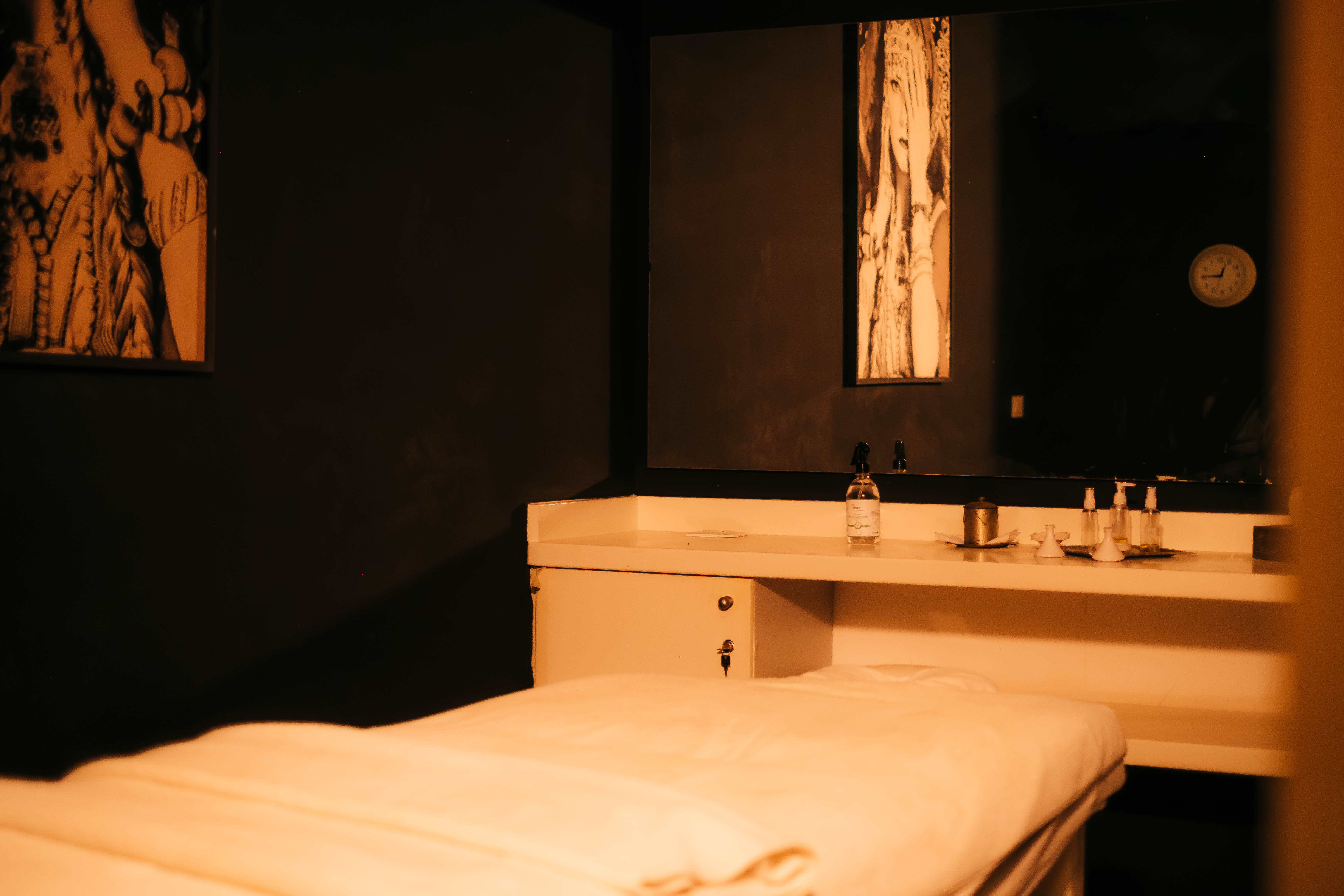 Comfortable seating area in a Moroccan riad with colorful patterned cushions against a backdrop of intricate zellige tiles, vibrant and detailed