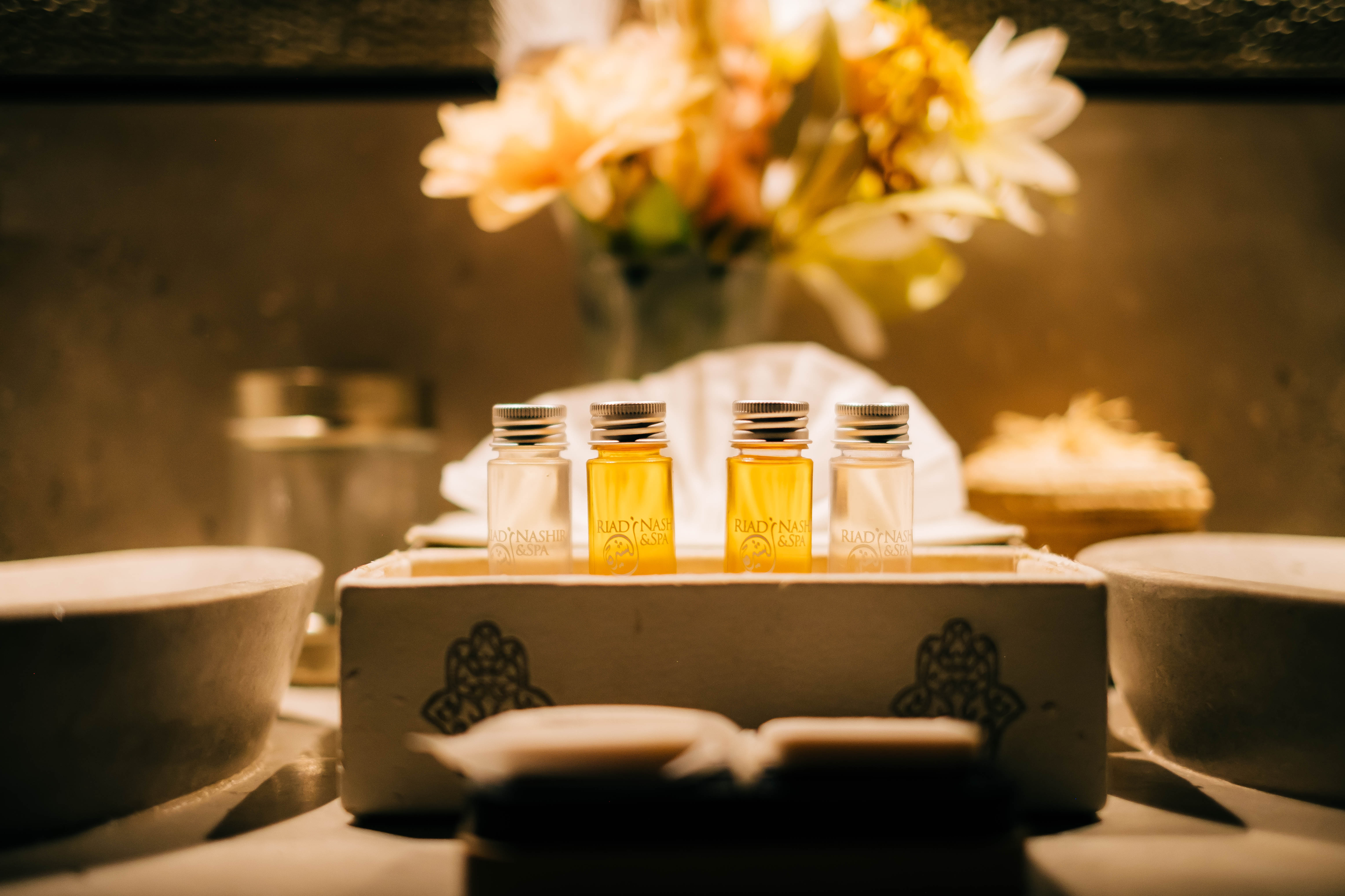 Cozy Moroccan comfort room at golden hour, warm ambient lighting, traditional decor, inviting atmosphere, luxury hotel photography