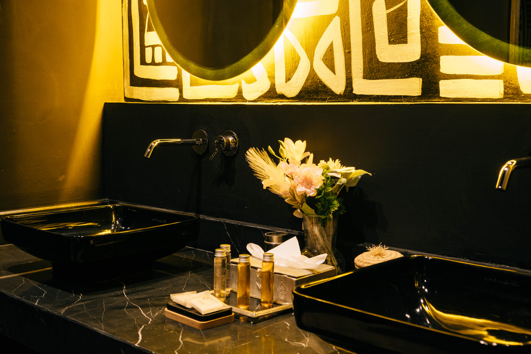 Cozy Moroccan comfort room at golden hour, warm ambient lighting, traditional decor, inviting atmosphere, luxury hotel photography