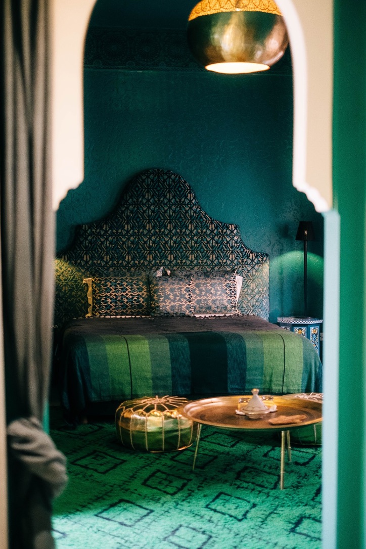 Intimate seating area in Moroccan comfort room with traditional cushions, low table, warm ambiance, authentic decor